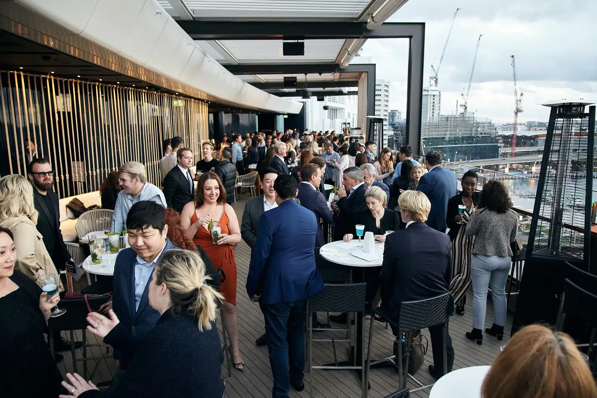 Small groups in conversation in an evening bar setting